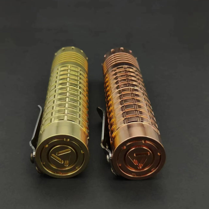 Two ReyLight Dawn - Brass flashlights on a black surface.