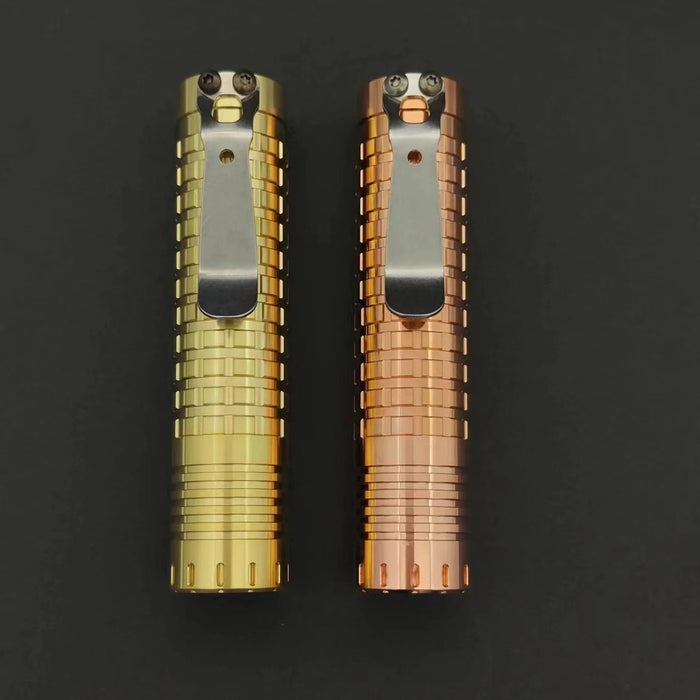 Two ReyLight Dawn - Brass lighters on a black surface.