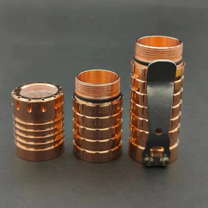 A set of ReyLight Dawn - Copper cylinders with a black lid.