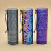 Three ReyLight Dawn Hex - Ti Anodized flashlights with pocket clips, each displaying a distinct color and texture, stand upright on a neutral background—each illuminated by a powerful Nichia 519a LED.
