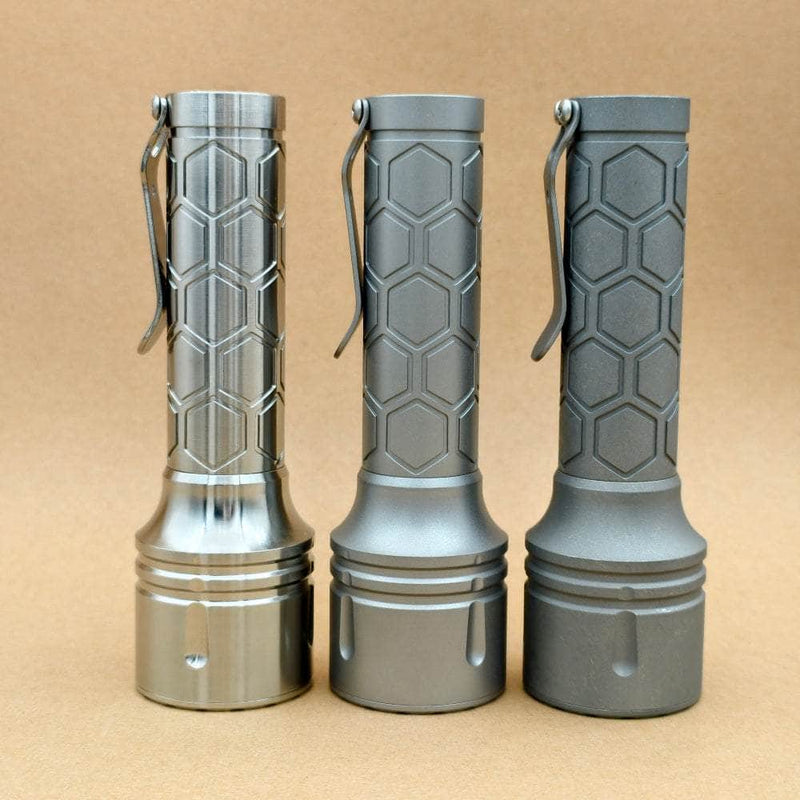 Side view of three ReyLight Dawn Max long-body flashlights with hexagonal machining