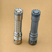 Angled view of the ReyLight LAN Ti Seigaiha tail buttons and sculpted titanium tailcaps