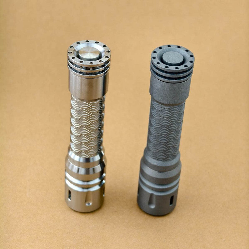 Angled view of the ReyLight LAN Ti Seigaiha tail buttons and sculpted titanium tailcaps