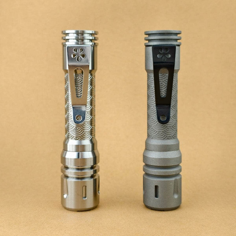 Rear view of Raw and Stonewashed ReyLight LAN Seigaiha titanium flashlights showing pocket clips