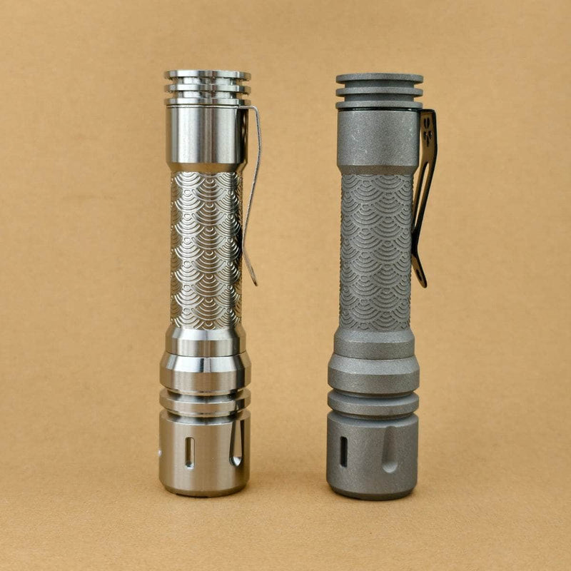 ReyLight LAN Ti Seigaiha flashlights in Raw and Stonewashed titanium with engraved wave-pattern bodies