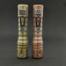 Two Reylight LANapple - Copper flashlights on a black surface.