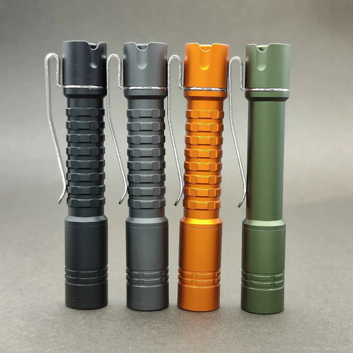 Four different colored flashlights, including the ReyLight Pineapple Mini Aluminum Flashlight, are placed on a gray surface.
Revised Sentence: Four different colored flashlights, including the ReyLight Pineapple Mini Aluminum flashlight, are placed on a gray surface.