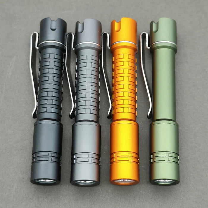 Four different colored ReyLight Pineapple Mini Aluminum flashlights on a gray surface.