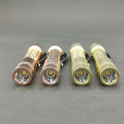 Four compact ReyLight Pineapple Mini Brass flashlights with metallic finishes arranged side by side.