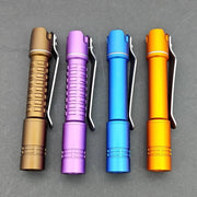 Four ReyLight Pineapple Mini MK II flashlights in brown, purple, blue, and orange with pocket clips are lined up on a gray background. They feature advanced Nichia 519a LEDs for superior illumination.