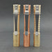 Three ReyLight Pineapple Mini MK II flashlights, with copper and brass textured bodies and silver clips, stand upright on a gray surface. Each uses the Nichia 519a LED for exceptional brightness. Compatible with a rechargeable 10440 battery, they effortlessly illuminate any setting.