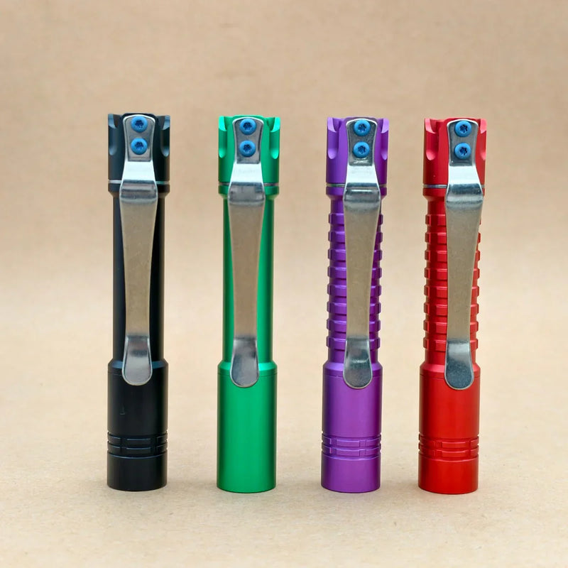 Four ReyLight Pineapple Mini MK3-Aluminum flashlights in black, green, purple, and red stand upright on a neutral background, showing off their clips, ridged grips, premium Nichia 519a LED, and support for rechargeable 10440 batteries.