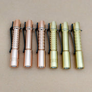Six ReyLight Pineapple Mini MK 3 pocket flashlights in copper and brass finishes are arranged side by side on a plain brown surface.