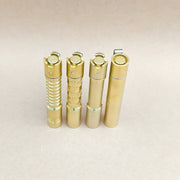 Four ReyLight Pineapple Mini MK3 EDC flashlights in copper and brass finishes, each featuring distinct metal textures, stand upright side by side on a plain beige surface.