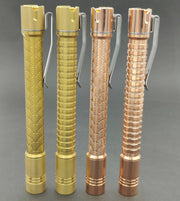 Four ReyLight Pineapple Mini Penlight - TI flashlights, each with unique engraved patterns and finishes, stand upright on a plain gray background.