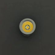 Close-up of the ReyLight Pineapple Mini Penlight - TI LED bulb against a black background, showcasing its yellow diode and metallic casing. This compact flashlight delivers 500 lumens of brightness.