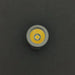 Close-up of the ReyLight Pineapple Mini Penlight - TI LED bulb against a black background, showcasing its yellow diode and metallic casing. This compact flashlight delivers 500 lumens of brightness.