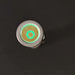 A round metallic object with a glowing green ring and hexagonal center sits on a black background, echoing the sleek design of the ReyLight Pineapple Mini Penlight - TI.