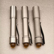 Rear view of Raw, Satin, and Stonewash Pineapple Mini stainless steel bodies and pocket clips