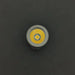 A close-up of a round Nichia 519a R9080 LED bulb with a yellow and silver exterior against a dark background, echoing the classic design of the ReyLight Pineapple Mini Ti - MK II.
