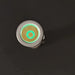 Close-up of a round metallic object with a glowing green circle and square pattern on top, reminiscent of the sleek ReyLight Pineapple Mini Ti - MK II, against a dark background.