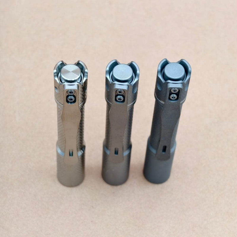 Angled view of Pineapple Mini MK3 Cross Hatch tail buttons and CNC titanium pocket clips
