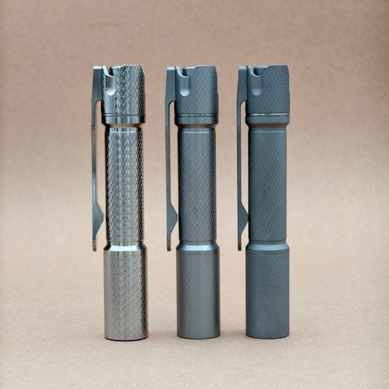 ReyLight Pineapple Mini MK3 Cross Hatch titanium flashlights in Raw, Beadblasted, and Stonewashed finishes
