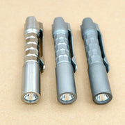 Three ReyLight Pineapple Mini Titanium MK3 - Krystal flashlights with hexagonal grips and clips are arranged side by side on a plain brown surface.
