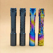 Four ReyLight Pineapple Mini Titanium Seigaiha - Anodized flashlights, each with a unique anodized finish, stand upright in a row on a plain tan background.