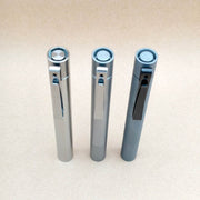 Close view of the titanium Cylinder penlight tail switches and pocket clips