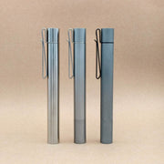Three ReyLight titanium Cylinder penlights standing upright with their pocket clips visible