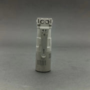 The ReyLight Rook - Ti, a compact gray cylinder with a textured grip and clip, stands upright against a neutral backdrop. It includes a bright Nichia 519a LED and is powered by a rechargeable 18350 battery.