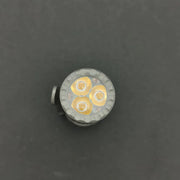 Close-up view of the ReyLight Rook - Ti with a Nichia 519a LED bulb featuring three lit diodes against a dark backdrop, powered by a rechargeable 18350 battery.