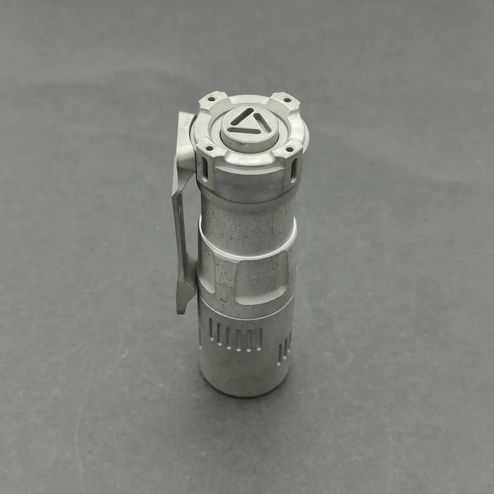 A Reylight Rook - Ti, a small metal container with a handle on it.