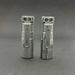 Two Reylight Rook - Ti cigarette lighters on a gray surface.