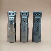 Three ReyLight Rook - Ti flashlights with dual LED bulbs and 18350 battery support stand upright on a plain, light brown surface against a matching background.