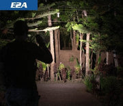 Skilhunt E2A beam illuminating trees on a forest trail