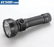 The Skilhunt EC500 is a black flashlight with a textured grip and a wide lens, offering 2100 lumens for maximum brightness. This USB-C rechargeable, long-range flashlight is ideal for easily illuminating distant targets.