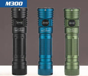Three Skilhunt M300 V4 flashlights stand upright in black, blue, and green against a plain background—each delivers 3000 lumens and features magnetic USB rechargeable capability.