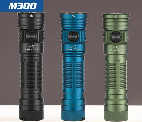 Three Skilhunt M300 V4 flashlights stand upright in black, blue, and green against a plain background—each delivers 3000 lumens and features magnetic USB rechargeable capability.