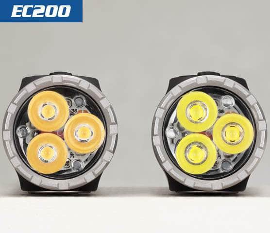 Two compact, multi-LED flashlights placed side by side, labeled "Skilhunt EC200." The left flashlight emits a warm yellow light while the right one shines with 2250 lumens of bright white light. Perfect as an EDC flashlight, both are USB-C rechargeable for convenience.