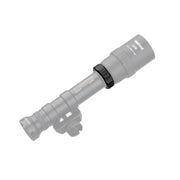 A Weltool DF2E V2 tactical flashlight is mounted on a rail, with most of the image faded except for the highlighted mounting hardware and the visible weapon light adapter attached to the rail.