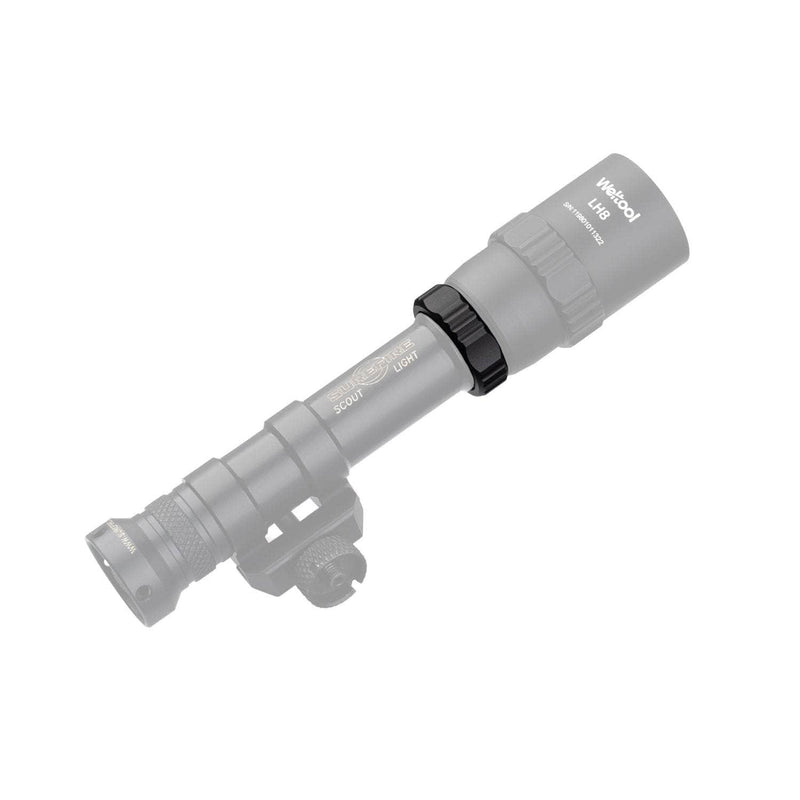 A Weltool DF2E V2 tactical flashlight is mounted on a rail, with most of the image faded except for the highlighted mounting hardware and the visible weapon light adapter attached to the rail.