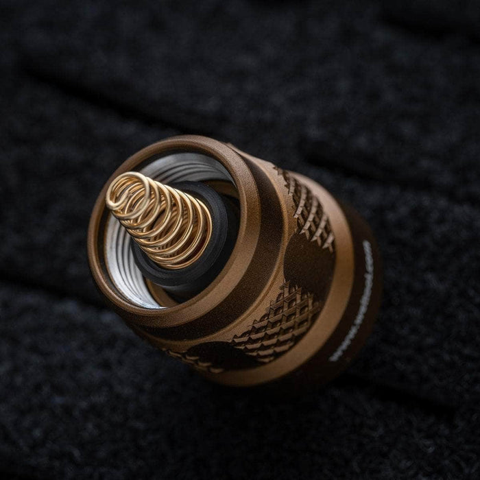 A Weltool TC68/TC68N Tailcap for W35/W65 atomizer on a black surface enhanced with black hard oxidation.