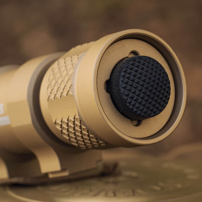 Close-up of the tan-colored Weltool TC70 Tailcap, designed for weapon lights, with a textured black rubber forward-clicking switch.