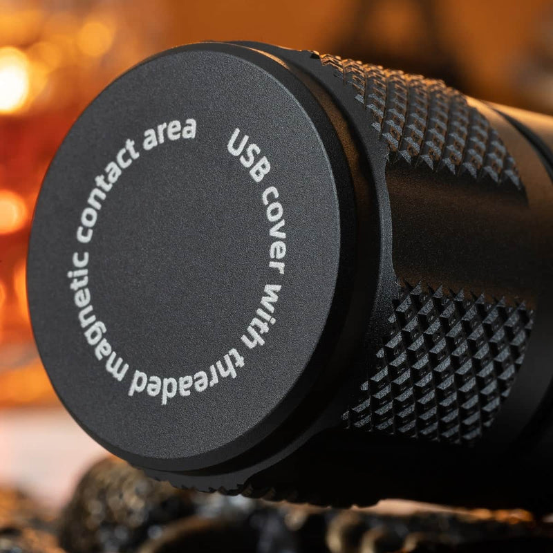 Close-up of the Weltool F9R, a cylindrical black rechargeable LED flashlight featuring a textured grip and a cap labeled "USB cover with threaded magnetic contact area.