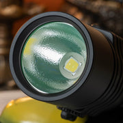 Close-up view of the lens and LED bulb of the black Weltool F9R rechargeable LED flashlight, highlighting the textured reflector inside the head.