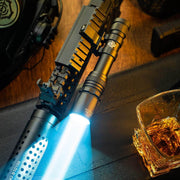 A Weltool LH20, a tactical rifle light with an aluminum reflector and 700-lumen output, sits beside a whiskey glass and gear on a dark surface.