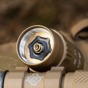 Close-up of the Weltool LH8 V2 Light Head, showing its tan finish, threaded battery compartment for a rechargeable lithium-ion cell, exposed metal spring, and visible light head details.