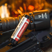 A Weltool T12 with multiple lighting options and a battery next to it.